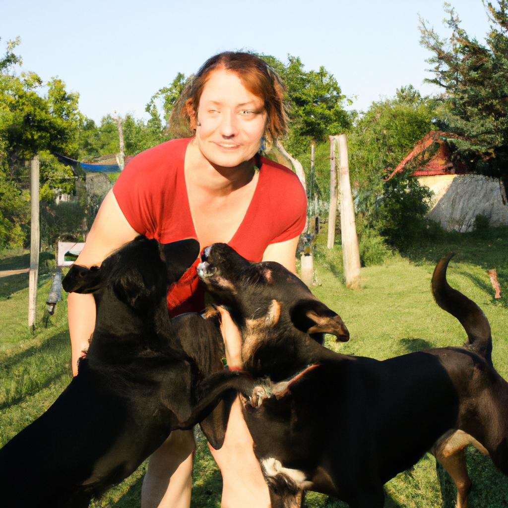 Woman playing with dogs, smiling
